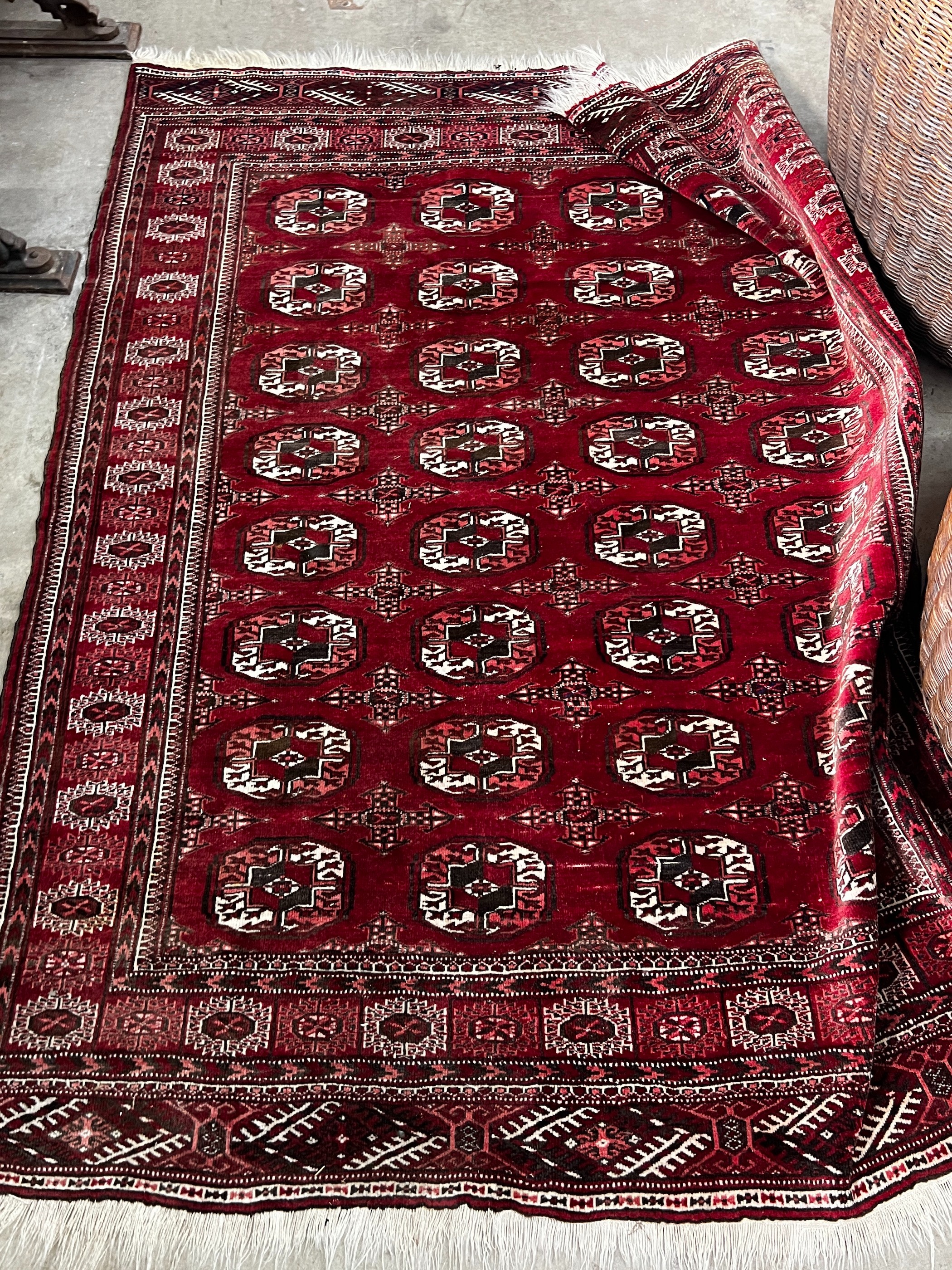 A Bokhara burgundy red ground rug, 180 x 150cm